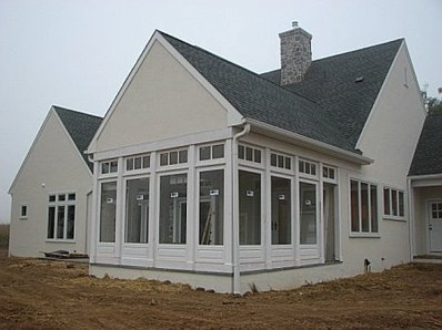 Three season porch with Brighton wall panels and divided lite transoms. 